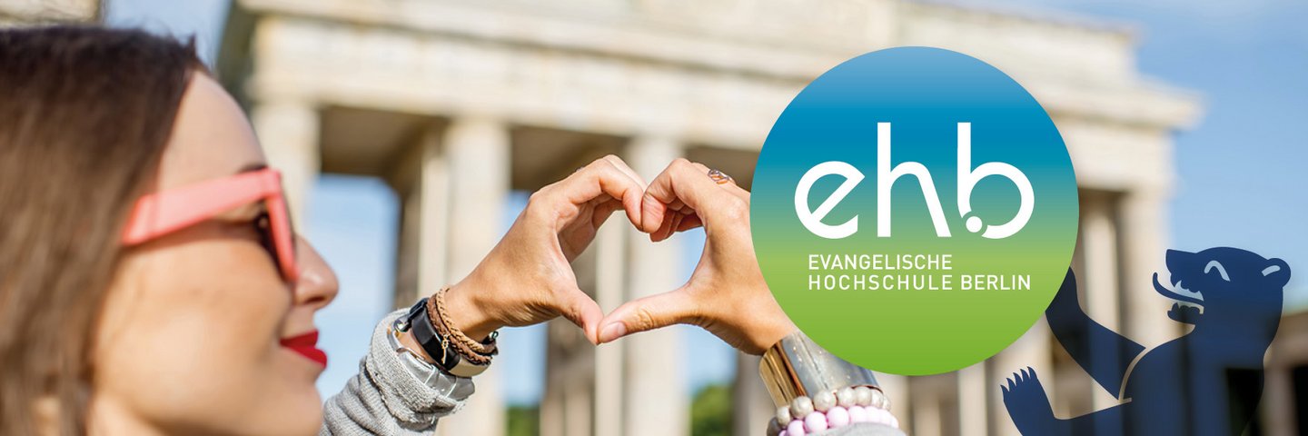 Young woman forming a heart with her hands in front of the Brandenburg Gate Berlin