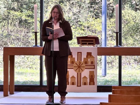 Eine weibliche Person sricht beim Gottesdienst